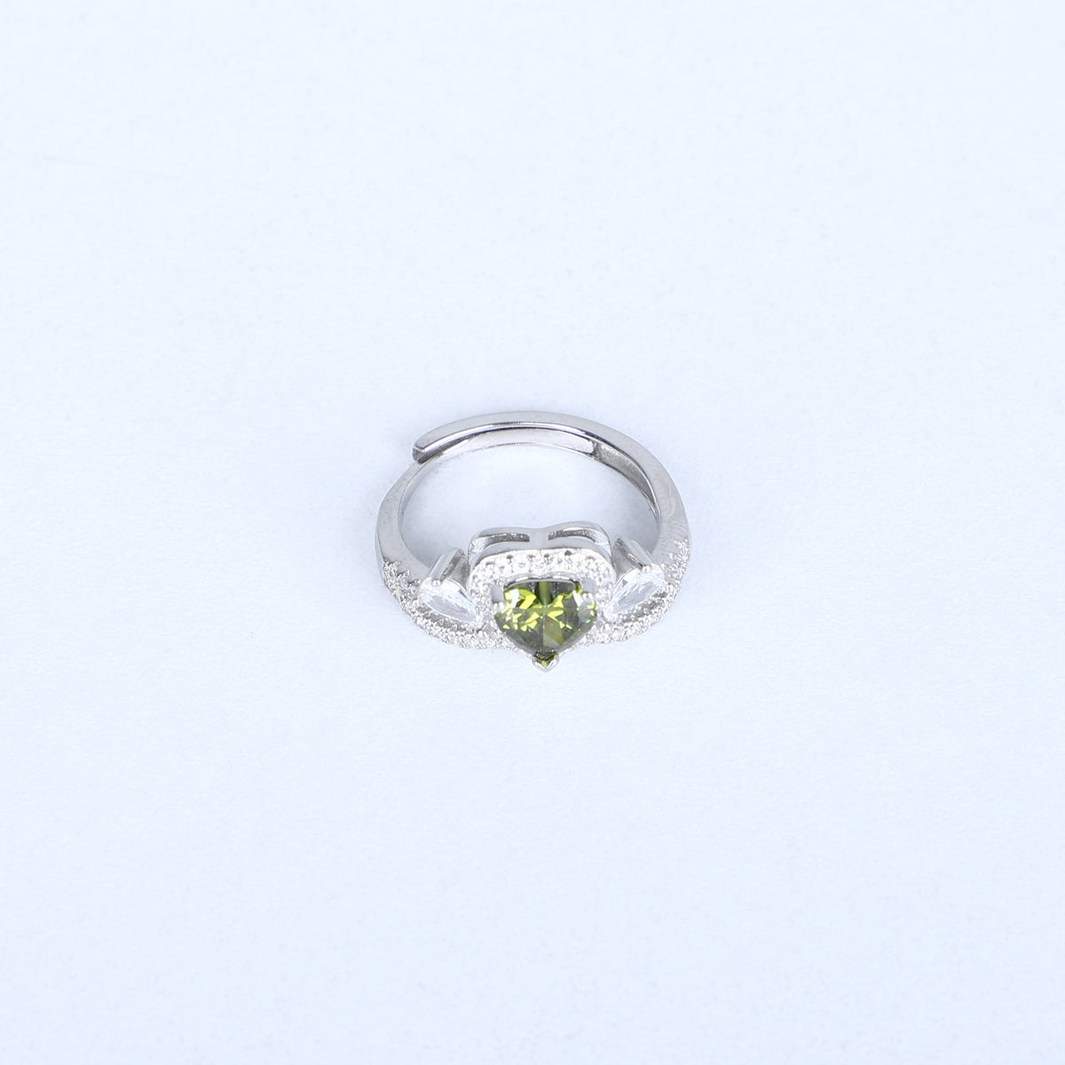 Women's heart shaped green gemstone ring – sparkling halo & twisted band design